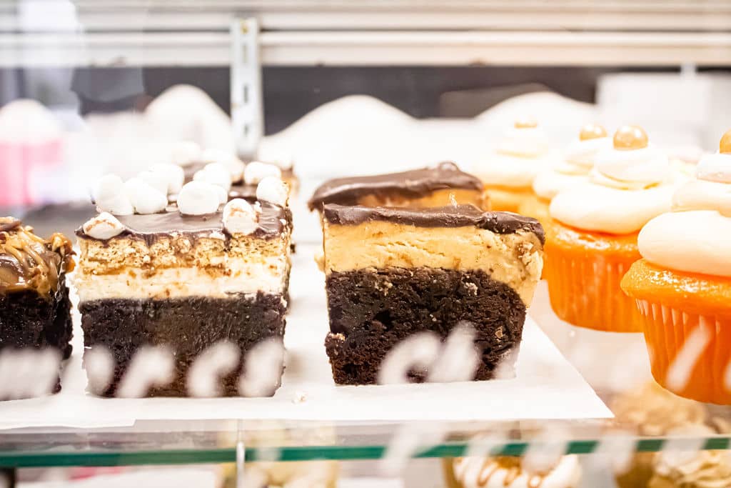 Delicious squares in a display case by Sugar Mama's Bake Shoppe