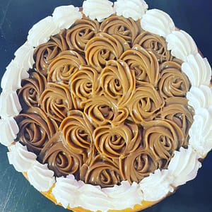 full-size cheesecake topped with icing